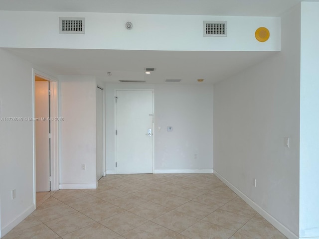 unfurnished room with light tile patterned floors