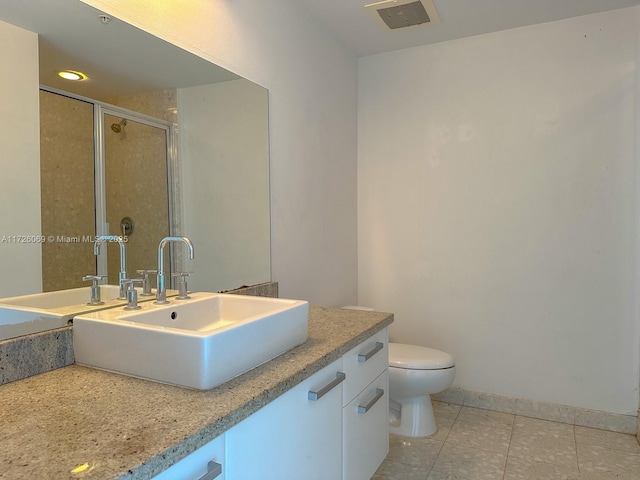 bathroom with tile patterned floors, an enclosed shower, vanity, and toilet