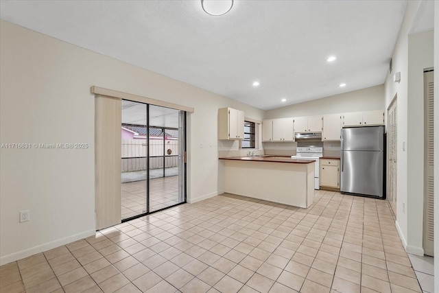 kitchen featuring kitchen peninsula, vaulted ceiling, stainless steel fridge, white range with electric stovetop, and white cabinetry