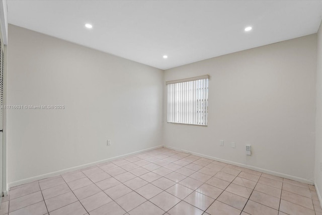 unfurnished room featuring light tile patterned floors