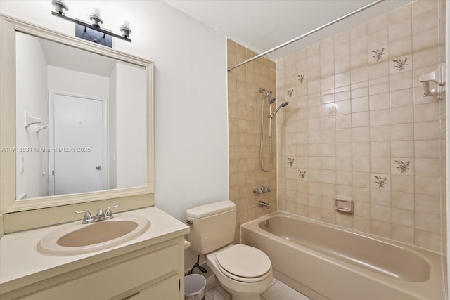 full bathroom featuring toilet, vanity, and tiled shower / bath