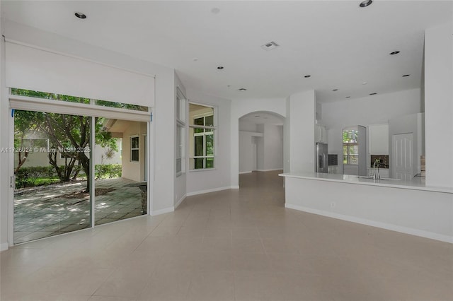 interior space featuring light tile patterned floors and sink