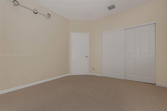 unfurnished bedroom featuring carpet and a closet