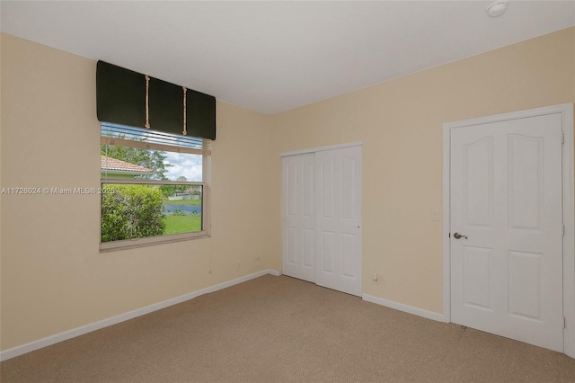 unfurnished bedroom with a closet and carpet