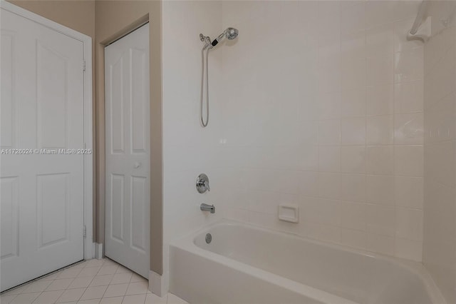 bathroom featuring tiled shower / bath combo and tile patterned flooring