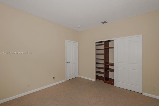 unfurnished bedroom with carpet and a closet