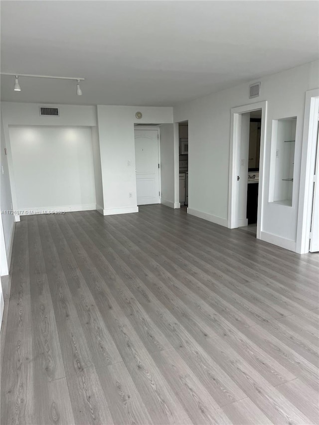 interior space featuring rail lighting and light wood-type flooring