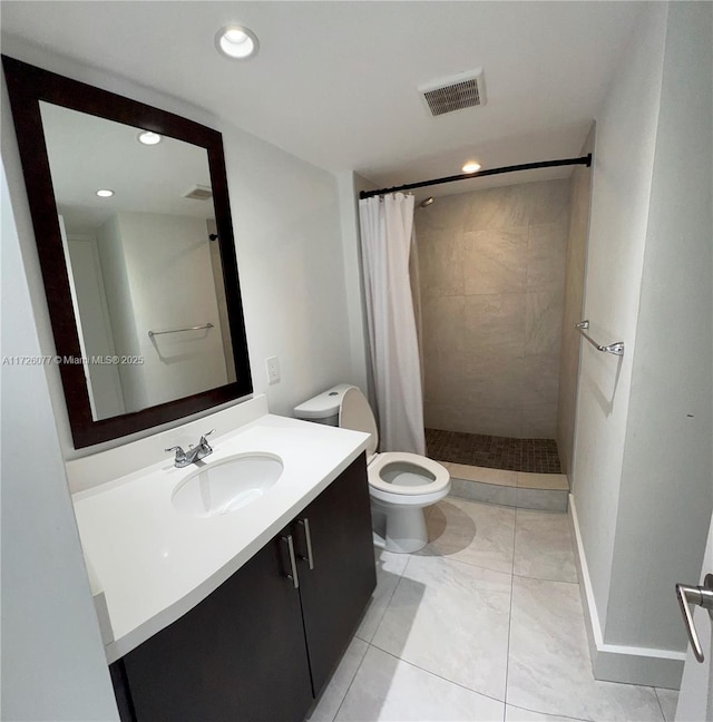 bathroom featuring toilet, vanity, and walk in shower