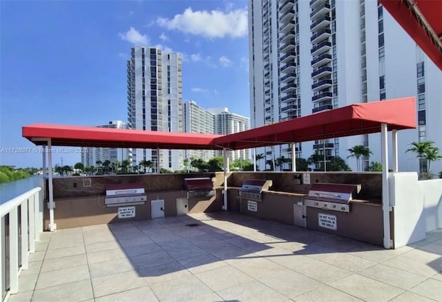 view of patio featuring an outdoor kitchen and a grill