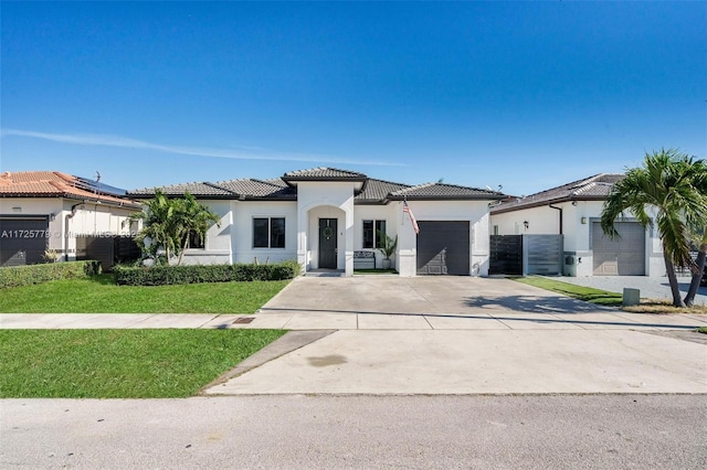 mediterranean / spanish home with a front yard and a garage