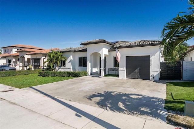 mediterranean / spanish-style home featuring a front yard and a garage