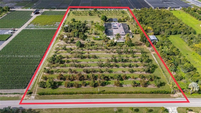 birds eye view of property with a rural view