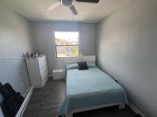 bedroom featuring ceiling fan and dark hardwood / wood-style floors