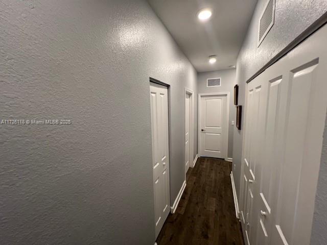 hallway featuring dark hardwood / wood-style floors