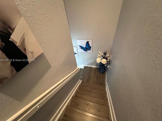 stairway featuring hardwood / wood-style flooring