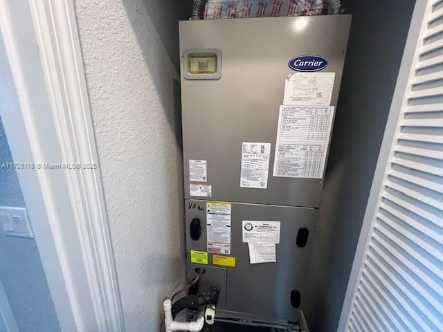 utility room featuring heating unit