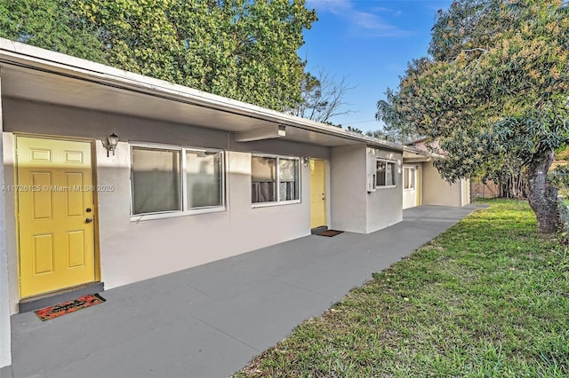 exterior space featuring a patio area and a front yard