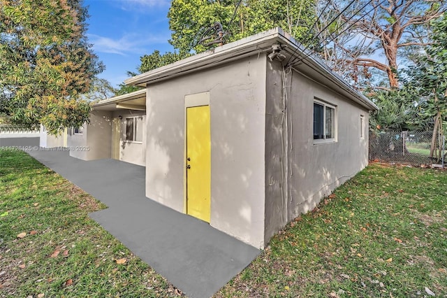 view of home's exterior featuring a patio area and a lawn