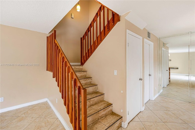 stairs with tile patterned floors