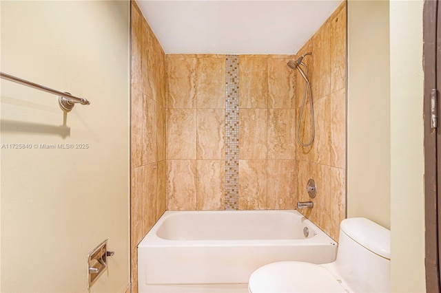 bathroom with toilet and tiled shower / bath combo