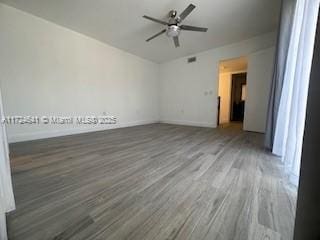 empty room featuring hardwood / wood-style flooring and ceiling fan