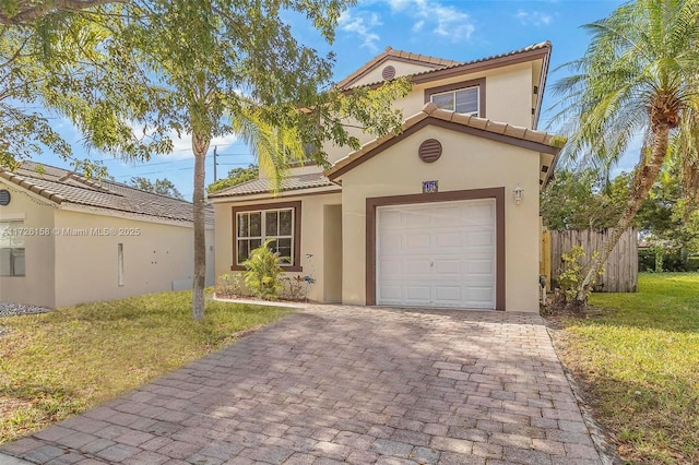 mediterranean / spanish-style house with a front lawn and a garage