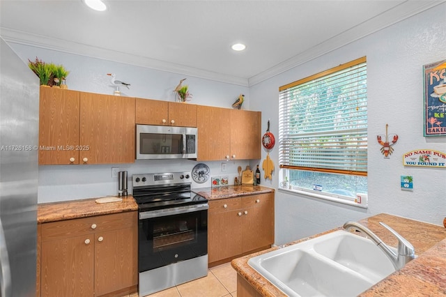 kitchen with stainless steel appliances, crown molding, light stone countertops, light tile patterned floors, and sink