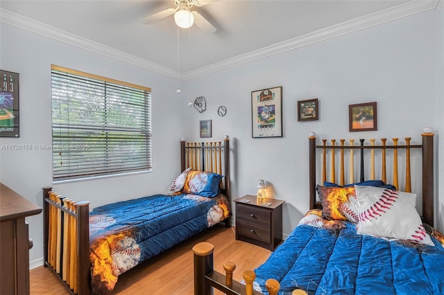 bedroom with ceiling fan, light wood-type flooring, and crown molding