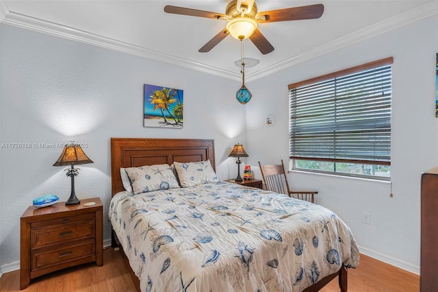 bedroom featuring ornamental molding, ceiling fan, and light hardwood / wood-style flooring