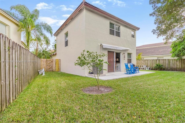 back of property featuring a lawn and a patio