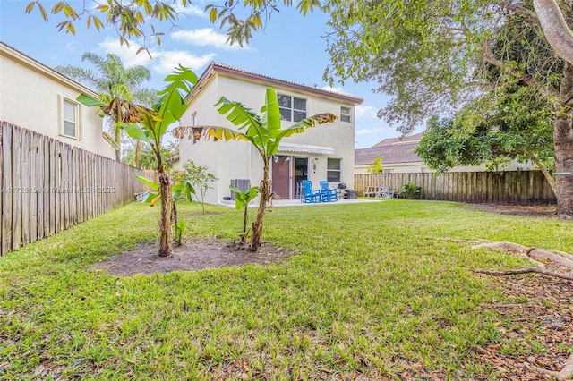 back of property with a patio and a lawn