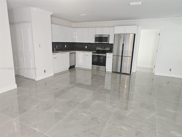 kitchen featuring sink, white cabinets, ornamental molding, and appliances with stainless steel finishes