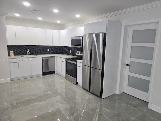 kitchen featuring sink, appliances with stainless steel finishes, tasteful backsplash, and white cabinetry