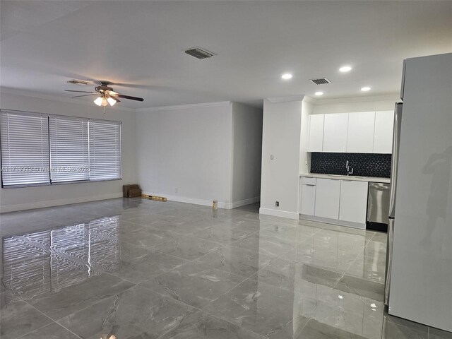 kitchen with crown molding, ceiling fan, refrigerator, decorative backsplash, and white cabinets