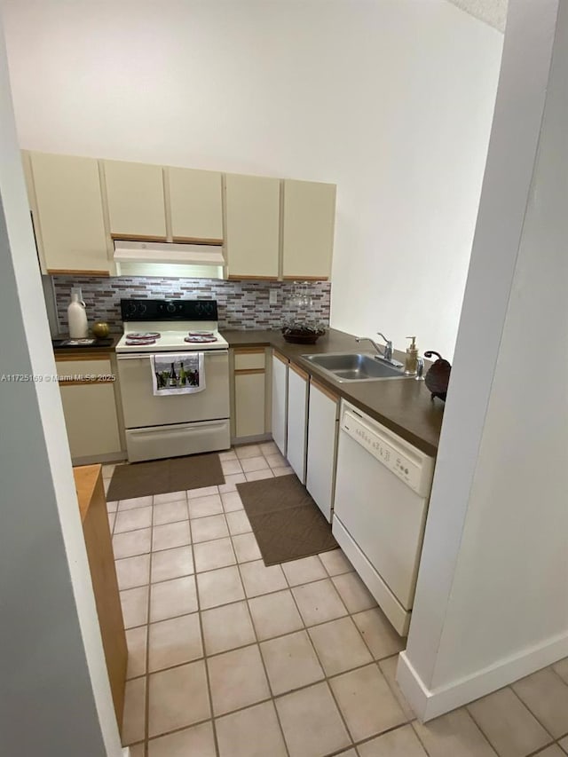 kitchen featuring sink, cream cabinets, white appliances, tasteful backsplash, and light tile patterned floors