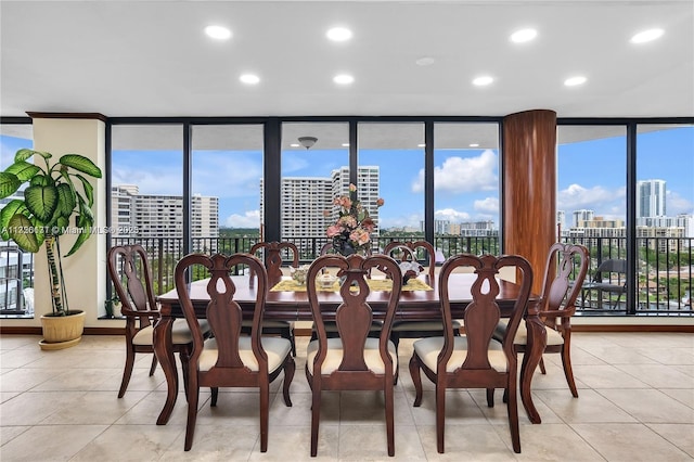 dining area with expansive windows and light tile patterned floors