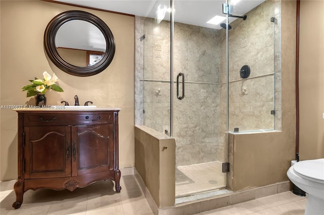 bathroom featuring toilet, tile patterned floors, walk in shower, and vanity