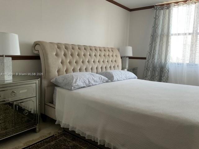 bedroom with crown molding and carpet flooring