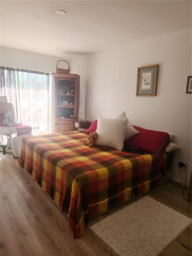 bedroom featuring wood-type flooring