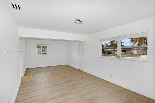 spare room featuring light hardwood / wood-style floors