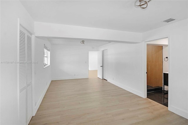 empty room with light hardwood / wood-style floors