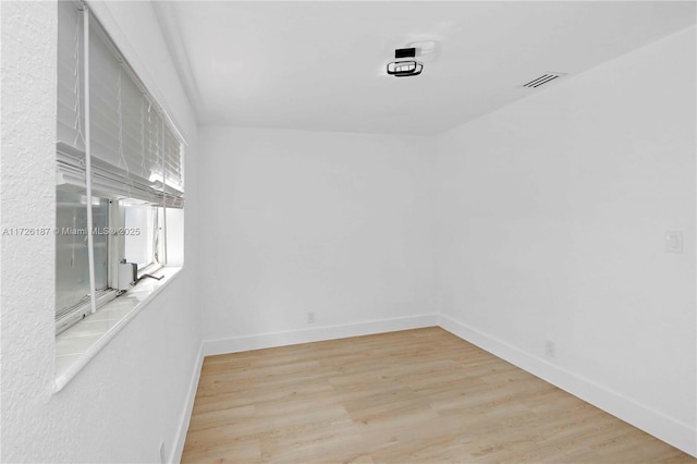 spare room featuring light hardwood / wood-style floors