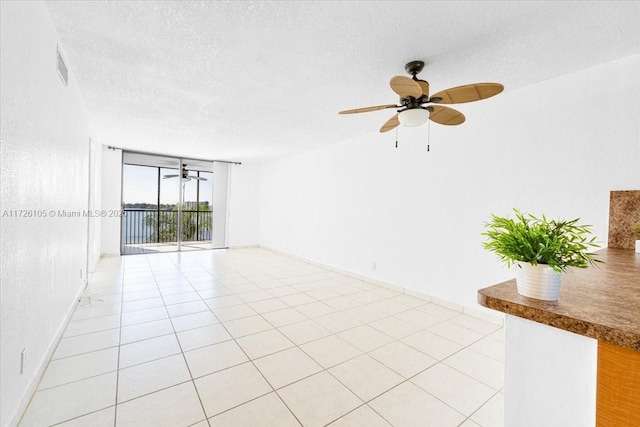 110 Lake Emerald Dr Unit 403, Oakland Park, FL 33309 - spare room with a textured ceiling, visible vents, a ceiling fan, and baseboards
