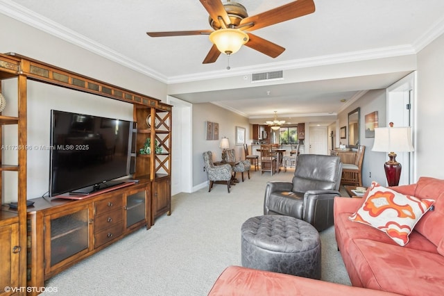 carpeted living room featuring ceiling fan with notable chandelier and crown molding