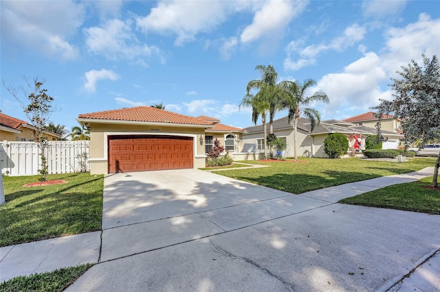 mediterranean / spanish-style home featuring a front yard and a garage