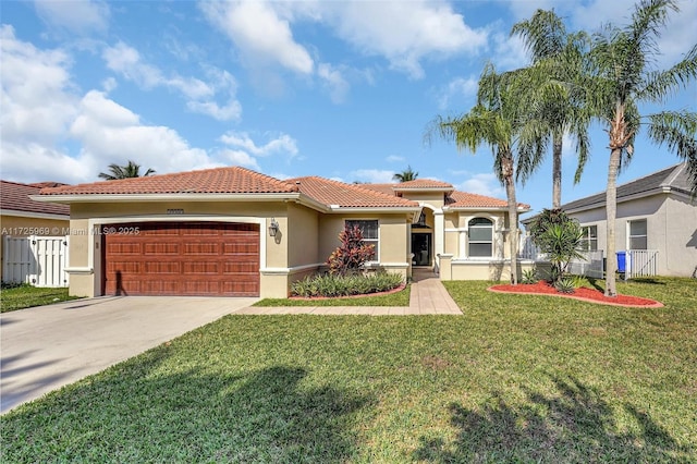 mediterranean / spanish-style home featuring a garage and a front lawn