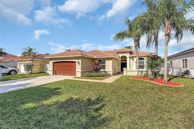 mediterranean / spanish home featuring a front lawn and a garage