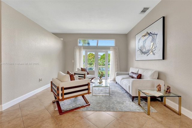 living room with french doors and light tile patterned flooring