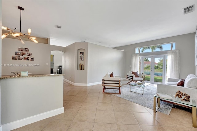 tiled living room featuring french doors