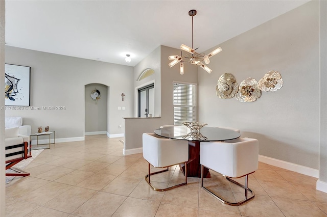 tiled dining space with an inviting chandelier